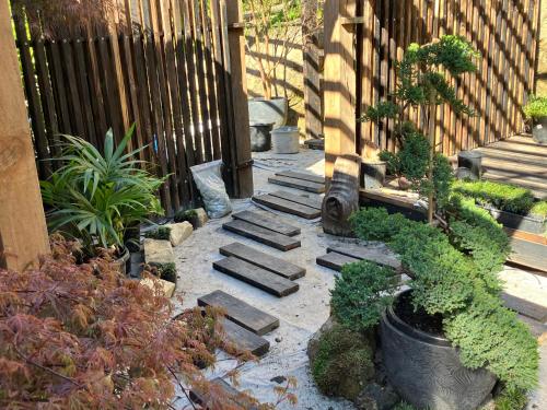 a garden with some plants and a fence at Kashikiri- Adelaide Hills Private Japanese Bath Retreat- pre-finished special in Crafers