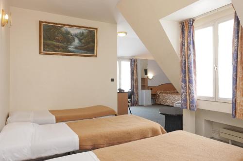 En eller flere senge i et værelse på Hotel Ferney République