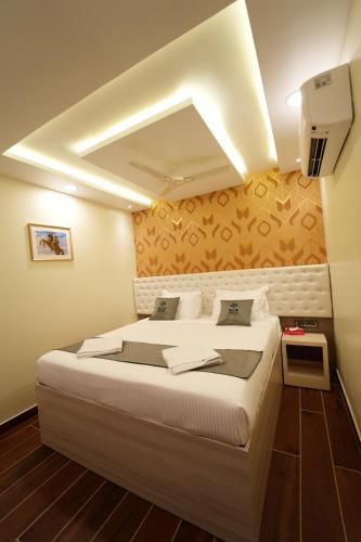 a bedroom with a large bed in a room at Mevid Hotels in Hyderabad