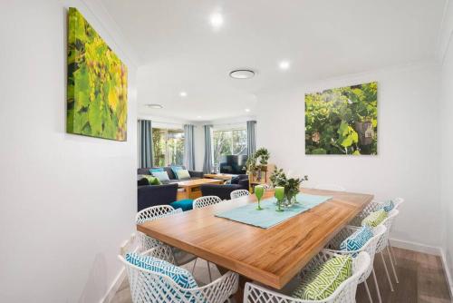 a living room with a wooden table and chairs at Busselton Family Holiday House - by the Bay in Geographe