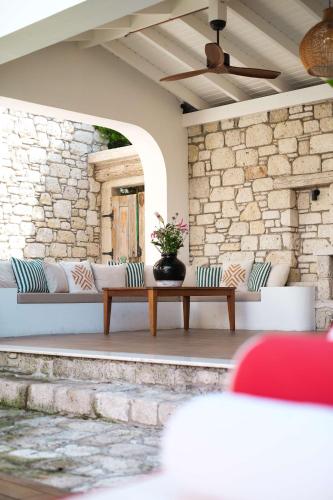 a patio with two couches and a table at Viento Alacati Hotel in Alacati