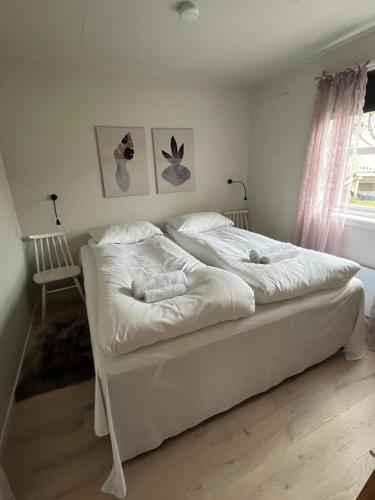 a bedroom with two beds with white sheets at Lena Apartment Tromsø in Kvaløya