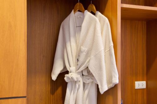 a group of white towels hanging on a wall at The View Rawada Phuket in Rawai Beach