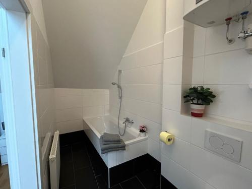 a bathroom with a sink and a bath tub at Paky Appartements 00323 in Bruck an der Leitha