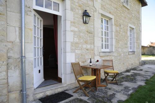 a patio with a table and chairs next to a building at Hapimag Château de Chabenet in Chabenet