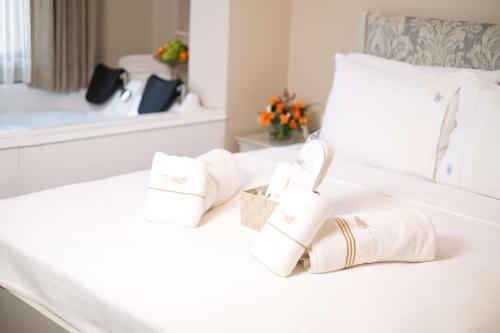 a bedroom with white towels and a bed at Viento Alacati Hotel in Alacati