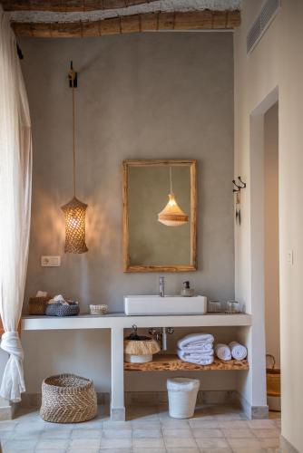 a bathroom with a sink and a mirror at Hostal Aljibe in Archidona