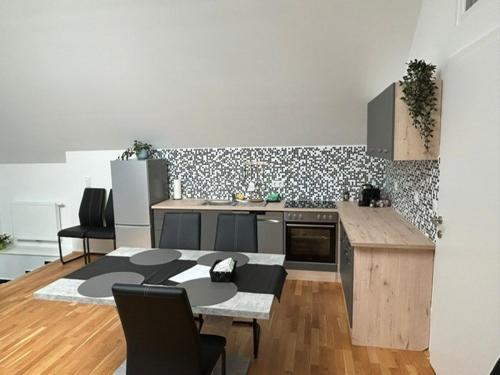 a kitchen with a table and a counter top at Paky Appartements 00323 in Bruck an der Leitha