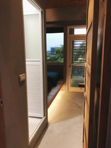 a door leading to a room with a window at DH House in Donghe
