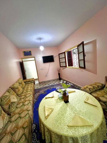 a living room with a table and a couch at Dar Diyafa in El Ksiba