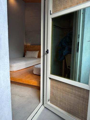 a door leading to a bedroom with a bed at DH House in Donghe
