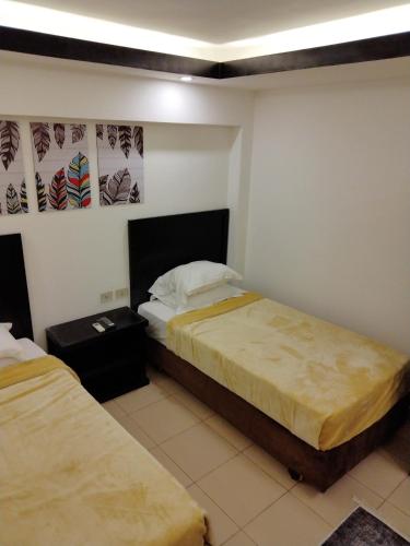 a hotel room with two beds in a room at Villa Silia in Sharm El Sheikh