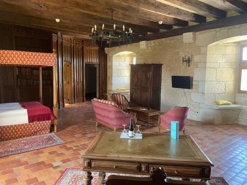 a living room with a bed and a table and chairs at Hapimag Château de Chabenet in Chabenet