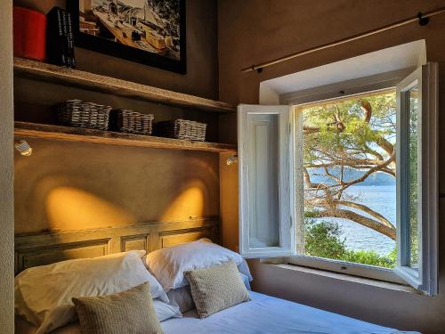 a bedroom with a bed and a window with a view at Tenuta Delle Ripalte in Capoliveri