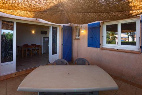 a table and chairs in a room with a patio at Résidence Padro in Calvi