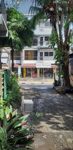 a palm tree in front of a building at Angel & Marie's Basic ACroom for 4-8pax in San Juan