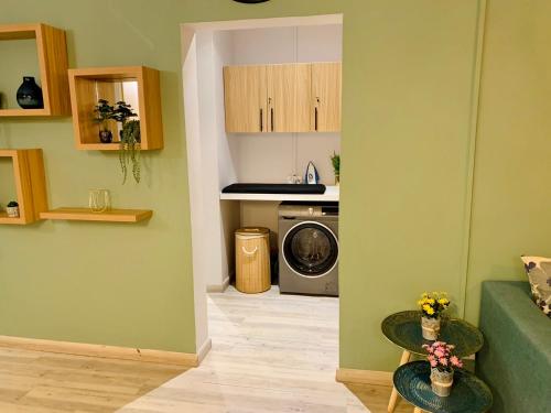 a living room with a washing machine and a kitchen at Ibiza Apartment - 150m from the beach in Flic-en-Flac