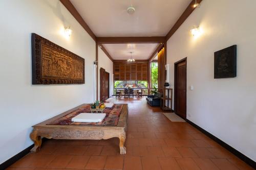 a hallway with a table in the middle of a room at Atoh's Maison in Siem Reap