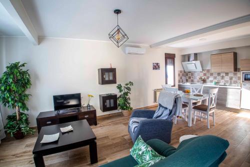 a living room with a couch and a table at AT la abuela Antonia- Ca Pablo in Torre de Don Miguel