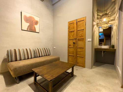 a living room with a couch and a table at DH House in Donghe