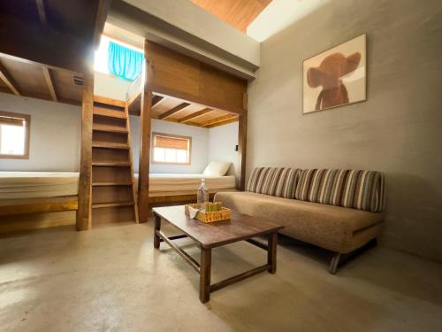 a living room with a couch and a table at DH House in Donghe