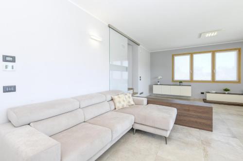 a living room with a white couch and a table at Villa Easy Life by Garda FeWo in Moniga