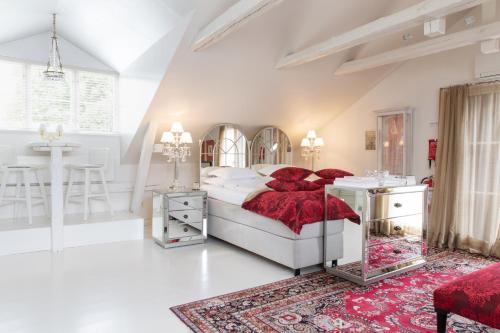 a white bedroom with a bed and a table at Bomans Hotell i Trosa in Trosa