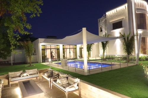 a villa with a swimming pool at night at Alhawameir rest in Wāsiţ