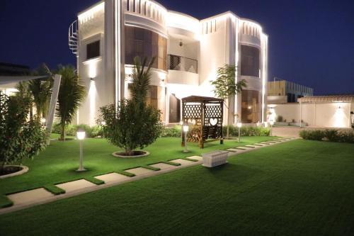 a large building with a lawn in front of it at Villa Alhawameir rest 1 in Wāsiţ