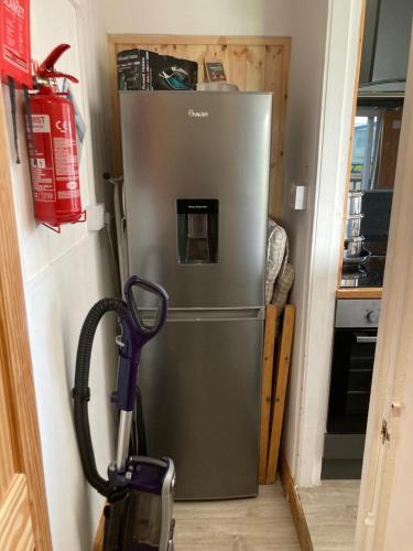 a refrigerator in a kitchen with a vacuum at F17 Rickardos Holiday Lets in Mablethorpe