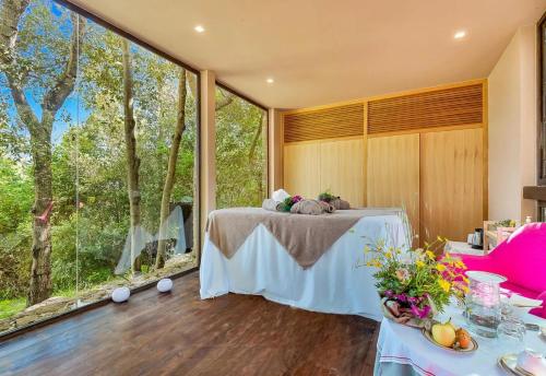 a room with a table and a large window at Villa Experience - Relais Il Termine Elba in Rio Marina