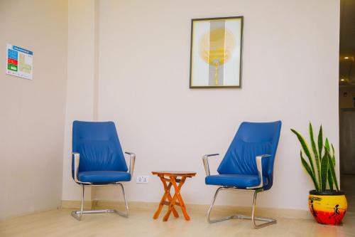 a waiting room with two blue chairs and a table at Best Western Dodoma City Hotel in Dodoma
