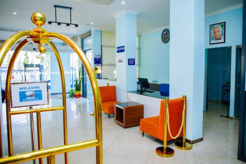 a lobby with orange chairs and a waiting room at Best Western Dodoma City Hotel in Dodoma