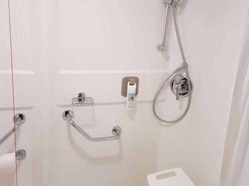 a white bathroom with a shower and a toilet at ibis Liverpool Centre Albert Dock – Liverpool One in Liverpool