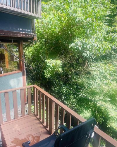 a balcony with a chair and a tree at えん吉野絶景広がる隠れ家1棟貸切ペットokサウナ室完備 in Yoshino