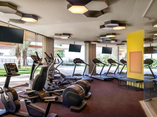 a gym with rows of treadmills and elliptical machines at Novotel Itu Terras de São José Golf & Resort in Itu