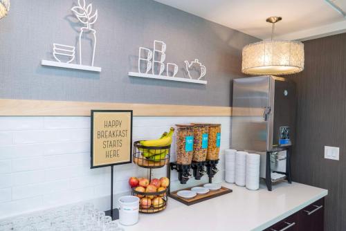 a kitchen with a counter with fruit and a refrigerator at Hampton Inn & Suites, by Hilton - Vancouver Downtown in Vancouver
