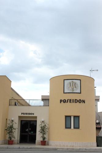 a building with a potleton sign on the side of it at Poseidon in Ispica