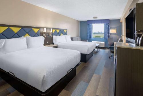 a hotel room with two beds and a kitchen at Days Hotel by Wyndham North Bergen in North Bergen