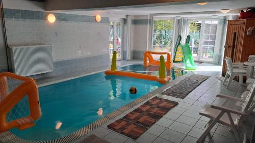 a indoor swimming pool with an inflatable at Villa Vranov 55 in Čerčany