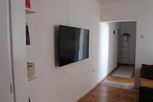 a flat screen tv on a wall in a living room at Cozy Apartment in Skopje in Skopje
