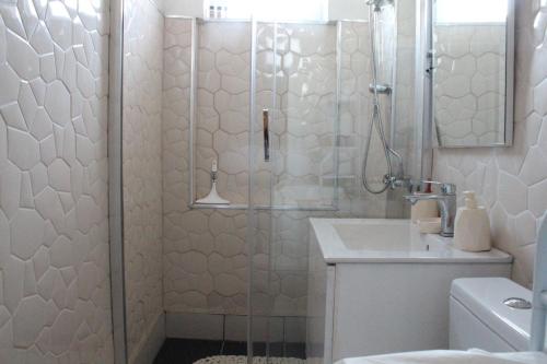 a bathroom with a shower and a sink at Cozy Apartment in Skopje in Skopje