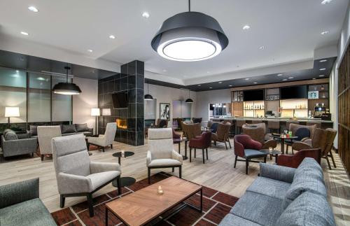 a lobby with couches and chairs and a bar at Hyatt Place Newark-Silicon Valley in Newark
