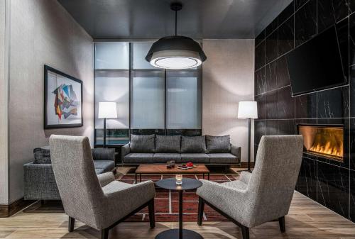 a living room with a couch and a fireplace at Hyatt Place Newark-Silicon Valley in Newark