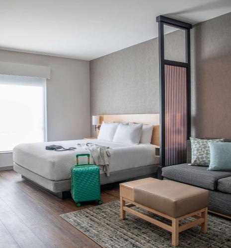a hotel room with a bed and a couch at Hyatt Place Newark-Silicon Valley in Newark
