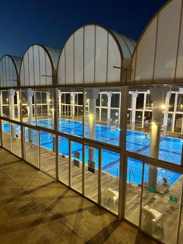a view of a large swimming pool at night at Habostan ceasarea, הבוסתן בקיסריה in Caesarea