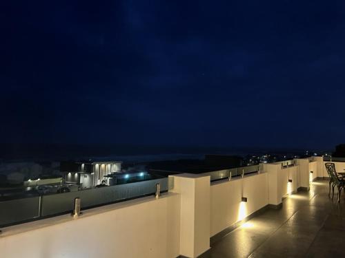 a building with a view of the ocean at night at Yzerfontein Villa Fantastica - No Loadshedding in Yzerfontein