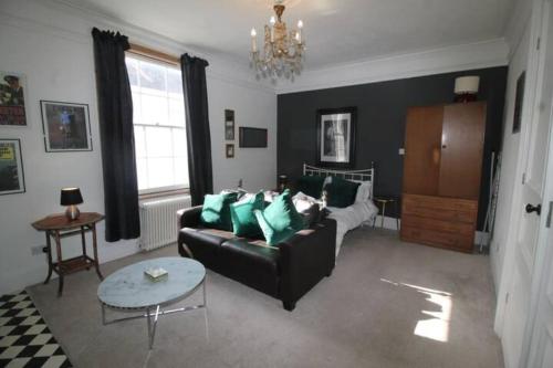 a living room with a couch and a table at City Centre Bolt Hole - Exeter in Exeter