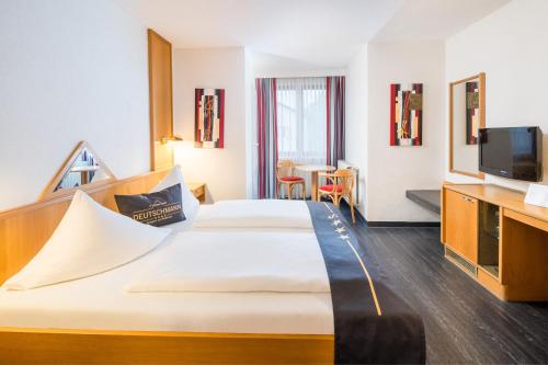 Postel nebo postele na pokoji v ubytování 4-Länder-Hotel Deutschmann
