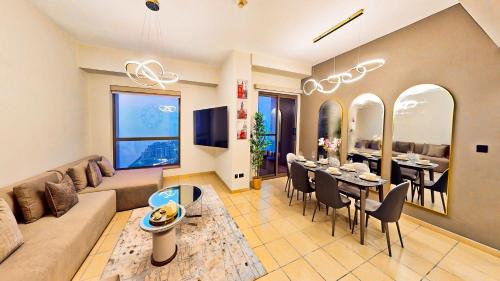 a living room with a couch and a dining room at Amazing views Dubai eye & Palm in Dubai